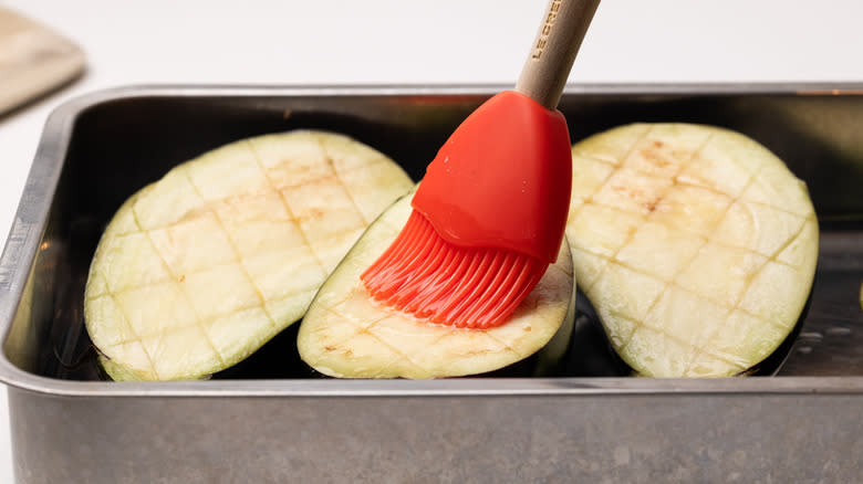 brushing eggplants with oil