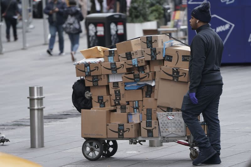 FILE PHOTO: An Amazon delivery person walks in Times Square following the outbreak of Coronavirus disease (COVID-19), in the Manhattan borough of New York City