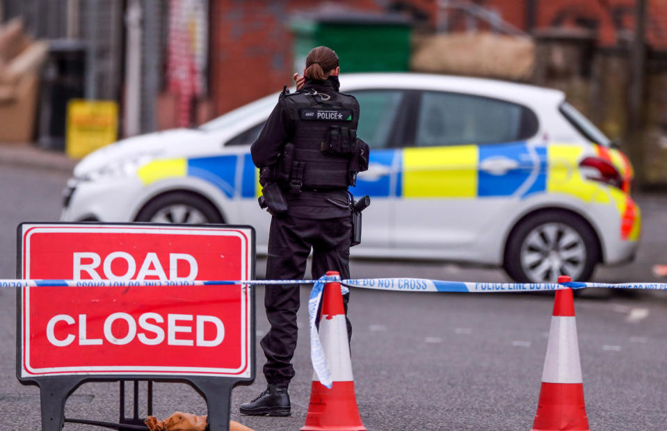 An armed police officer at the scene on King Street, Blackburn, following the death of a woman from a suspected gunshot wound on Sunday. PA Photo. Picture date: Monday May 18, 2020.See PA story POLICE Blackburn. Photo credit should read: Peter Byrne/PA Wire         