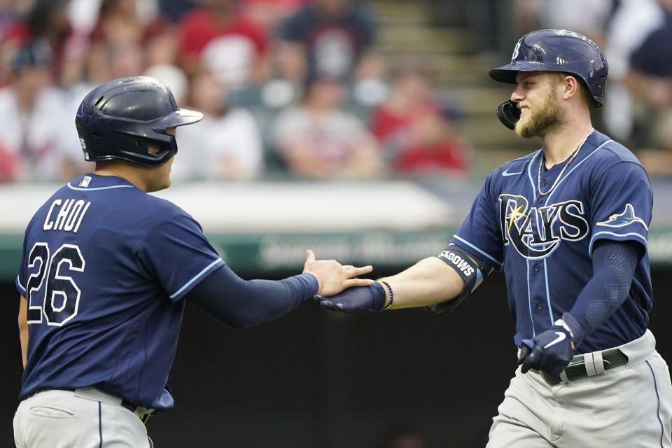 Tampa Bay Rays' Austin Meadows, right, is congratulated by Ji-Man Choi after Meadows hit a two-run home run during the third inning of the team's baseball game against the Cleveland Indians, Saturday, July 24, 2021, in Cleveland. (AP Photo/Tony Dejak)