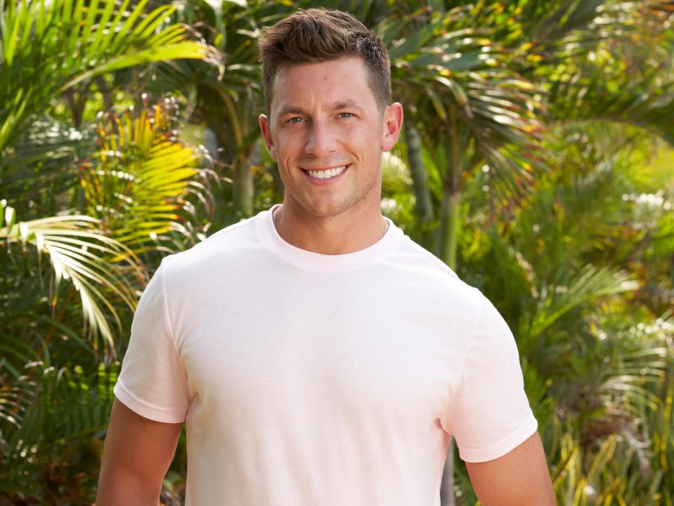 Peter Cappio poses in a pink shirt and white shorts on "Bachelor in Paradise" season 9.