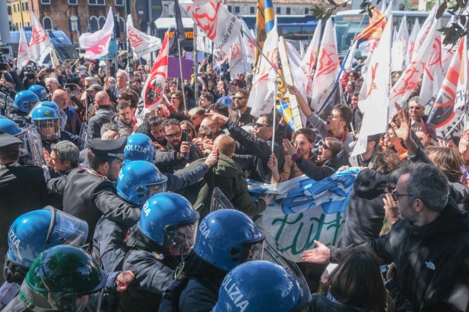 A police blockade at Piazzale Roma holds back anti-access fee protestors on Thursday. Getty Images