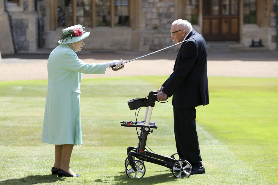 Captain Sir Thomas Moore receives his knighthood from Britain's Queen Elizabeth, during a ceremony at Windsor Castle in Windsor, England, Friday, July 17, 2020. Captain Sir Tom raised almost £33 million for health service charities by walking laps of his Bedfordshire garden. (Chris Jackson/Pool Photo via AP)