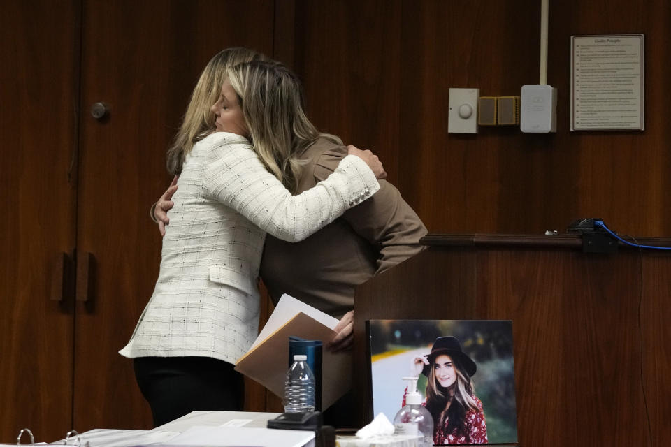 Oakland County prosecutor Karen McDonald hugs Nicole Beausoleil, mother of Madisyn Baldwin, after Nicole's victim impact statement, Friday, Dec. 8, 2023, in Pontiac, Mich. Parents of students killed at Michigan's Oxford High School described the anguish of losing their children Friday as a judge considered whether Ethan Crumbley, a teenager, will serve a life sentence for a mass shooting in 2021. (AP Photo/Carlos Osorio)