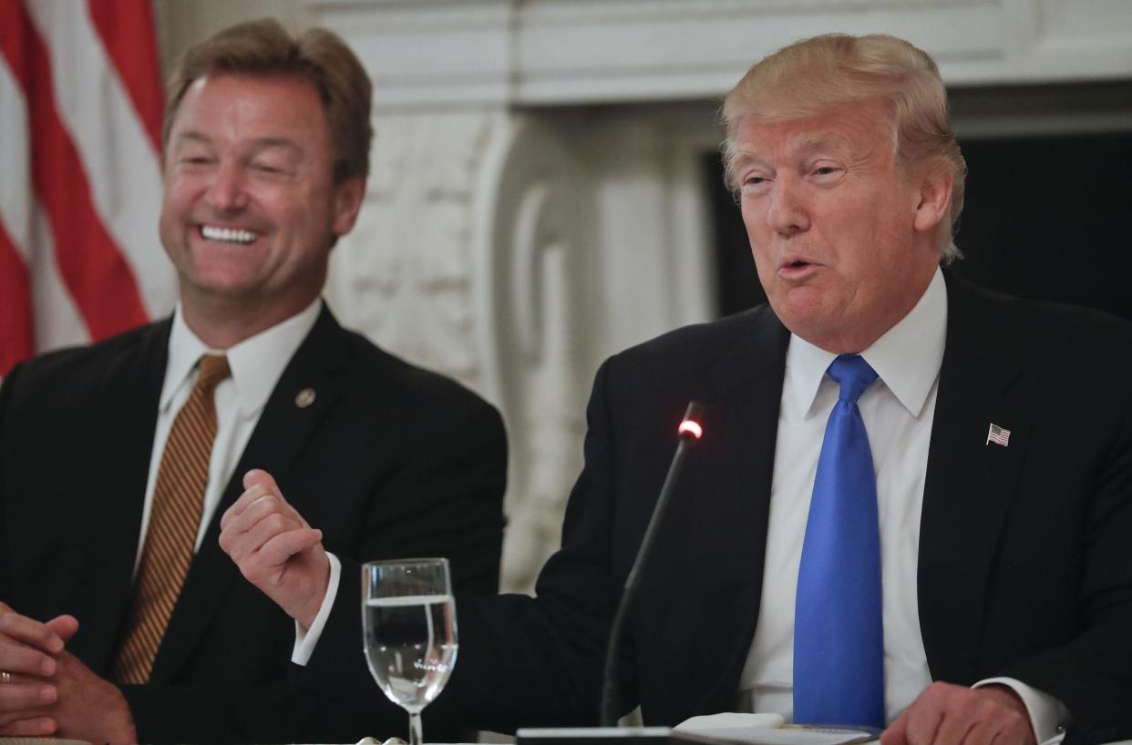 President Donald Trump gestures towards Senator Dean Heller while speaking during a luncheon: AP