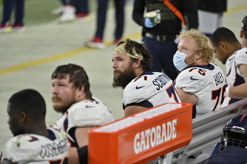 Denver Broncos offensive guard Austin Schlottmann (71) watches from the bench beside teammates as they trail the Las Vegas Raiders during the second half of an NFL football game, Sunday, Nov. 15, 2020, in Las Vegas. (AP Photo/David Becker)