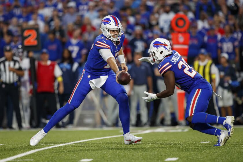 Buffalo Bills quarterback Josh Allen (17) hands the ball off to running back Devin Singletary (26) during an NFL football game, Monday, Sept. 19, 2022, in Orchard Park, NY. (AP Photo/Matt Durisko)