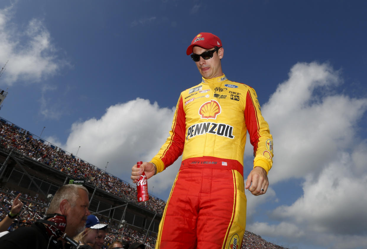 Joey Logano walks off the stage at Talladega Superspeedway, Sunday, Oct. 15, 2017, in Talladega, Ala. (AP Photo/Brynn Anderson)