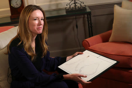 Clare Waight Keller, designer at Givenchy, holds sketches as she gives an interview the day after Meghan Markle walked down the aisle of St George's Chapel in Windsor and married Prince Harry wearing the dress that she created, in Kensington Palace, London, Britain, May 20, 2018. REUTERS/Hannah McKay/Pool