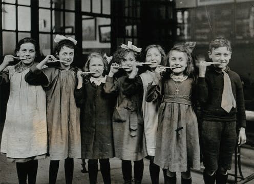 <span class="caption">Compared to previous censuses, the 1921 data shows more children in education.</span> <span class="attribution"><a class="link " href="https://upload.wikimedia.org/wikipedia/commons/4/44/Tooth-brush_drill_at_school%2C_England%3B_children_pose_with_Wellcome_V0030839.jpg" rel="nofollow noopener" target="_blank" data-ylk="slk:Wellcome Collection;elm:context_link;itc:0;sec:content-canvas">Wellcome Collection</a>, <a class="link " href="http://creativecommons.org/licenses/by-sa/4.0/" rel="nofollow noopener" target="_blank" data-ylk="slk:CC BY-SA;elm:context_link;itc:0;sec:content-canvas">CC BY-SA</a></span>