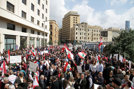 Protesters wave Lebanese national flags during a demonstration against proposed tax increase, in front of the government palace in Beirut, Lebanon March 19, 2017. REUTERS/Alia Haju