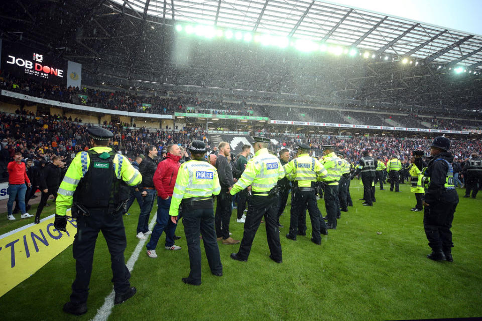 Police and security contain Mansfield fans after a match at Milton Keynes Dons. (Photo by Bryn Lennon/Getty Images)