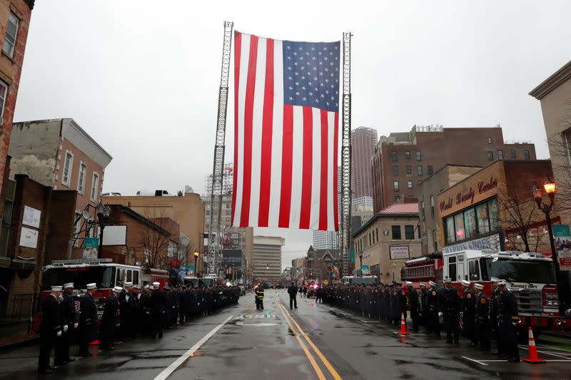 Police officers and firefighters gather on street ahead of funeral service for Jersey City Police Detective Joseph Seals in Jersey City