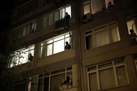 People stand at their windows, some of them hitting pots and pans, during an anti-government demonstration at the Besiktas district in Istanbul, Turkey, April 17, 2017. REUTERS/Alkis Konstantinidis