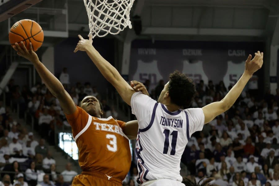 Texas guard Max Abmas (3) makes a basket as TCU guard Trevian Tennyson (11) defends during the second half of an NCAA college basketball game in Fort Worth, Texas, Saturday, Feb. 3, 2024. (AP Photo/Michael Ainsworth)