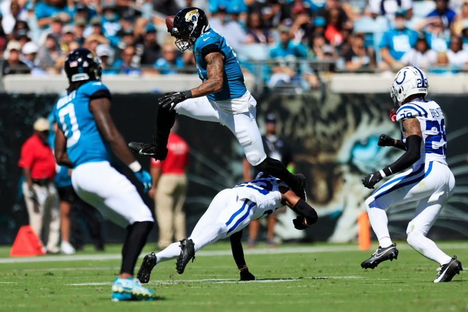 Jacksonville Jaguars tight end Evan Engram (17) hurdles Indianapolis Colts cornerback Kenny Moore II (23) during the second quarter of an NFL football matchup Sunday, Oct. 15, 2023 at EverBank Stadium in Jacksonville, Fla.