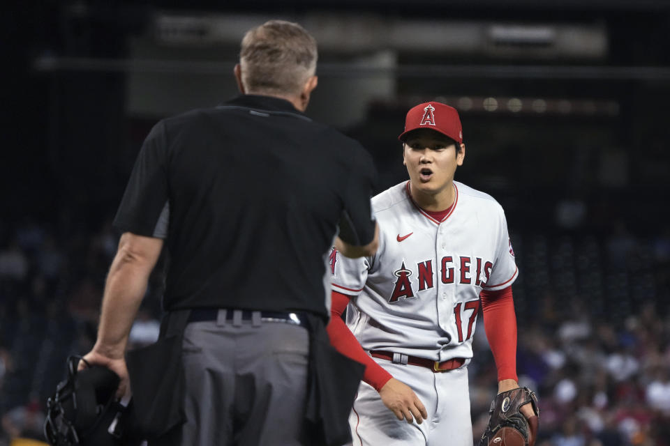 Los Angeles Angels pitcher Shohei Ohtani (17) talks tumpire Greg Gibson after getting called for his second balk, in the fifth inning of the team's baseball game against the Arizona Diamondbacks, Friday, June 11, 2021, in Phoenix. (AP Photo/Rick Scuteri)