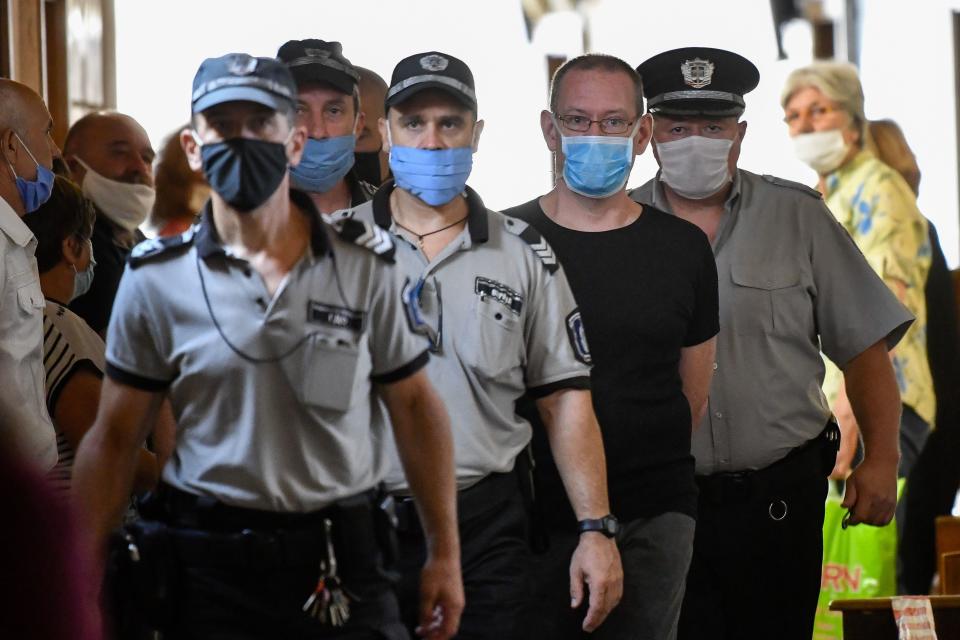 British suspect Daniel Erickson-Hull (2nd-R) is escorted into court in the city of Sliven, on July 17, 2020. - The trial of a British man convicted in the UK of possessing child pornography opened in Bulgaria Friday on charges of sexually abusing eight underage boys in a poor Roma community. Their families have refused to press for civil damages, however. Daniel Erickson-Hull, 44, was detained last September in the central town of Sliven, where he was a self-proclaimed evangelical preacher. (Photo by NIKOLAY DOYCHINOV / AFP) (Photo by NIKOLAY DOYCHINOV/AFP via Getty Images)