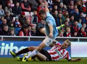 Sunderland's Sebastian Larsson (R) challenges Manchester City's James Milner during their English Premier League soccer match at The Stadium of Light in Sunderland, northern England, November 10, 2013.