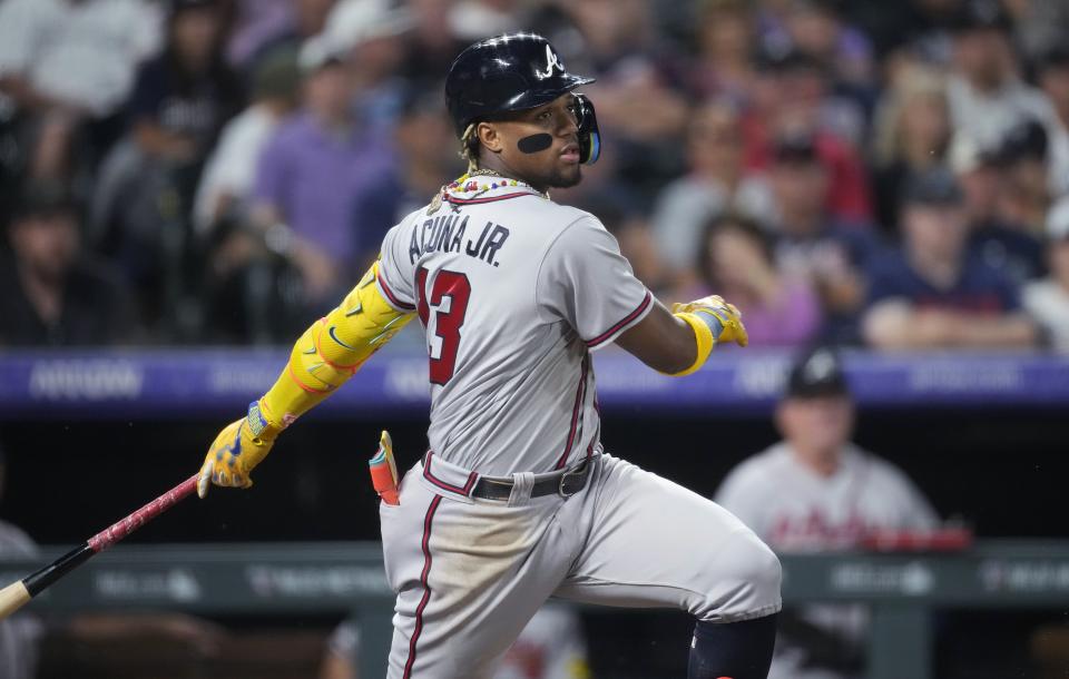 Atlanta Braves' Ronald Acuña Jr. watches a single against the Colorado Rockies during the sixth inning of a baseball game Tuesday, Aug. 29, 2023, in Denver. (AP Photo/David Zalubowski)