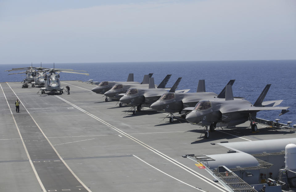 Military personnel inspect US and British jets as they participate in the NATO Steadfast Defender 2021 exercise on board the aircraft carrier HMS Queen Elizabeth off the coast of Portugal, Thursday, May 27, 2021. NATO has helped provide security in Afghanistan for almost two decades but the government and armed forces in the conflict-torn country are strong enough to stand on their own feet without international troops to back them, the head of the military organization said Thursday. (AP Photo/Ana Brigida)