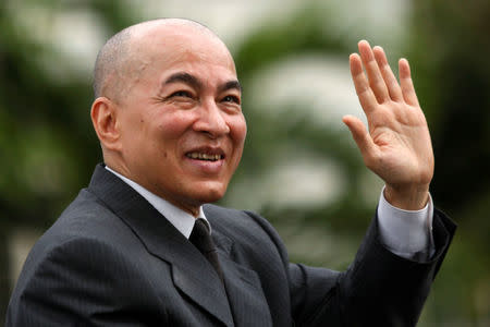 Cambodia's King Norodom Sihamoni waves from a car during the celebration marking the 64th anniversary of the country's independence from France, in Phnom Penh, Cambodia November 9, 2017. REUTERS/Samrang Pring