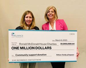 Reliance President and CEO Karla Lewis (left) presents $1 million donation check to RMHC Global President and CEO, Katie Fitzgerald