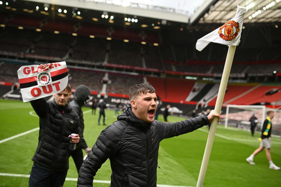 Manchester United fans on the pitch at Old Trafford (Getty)