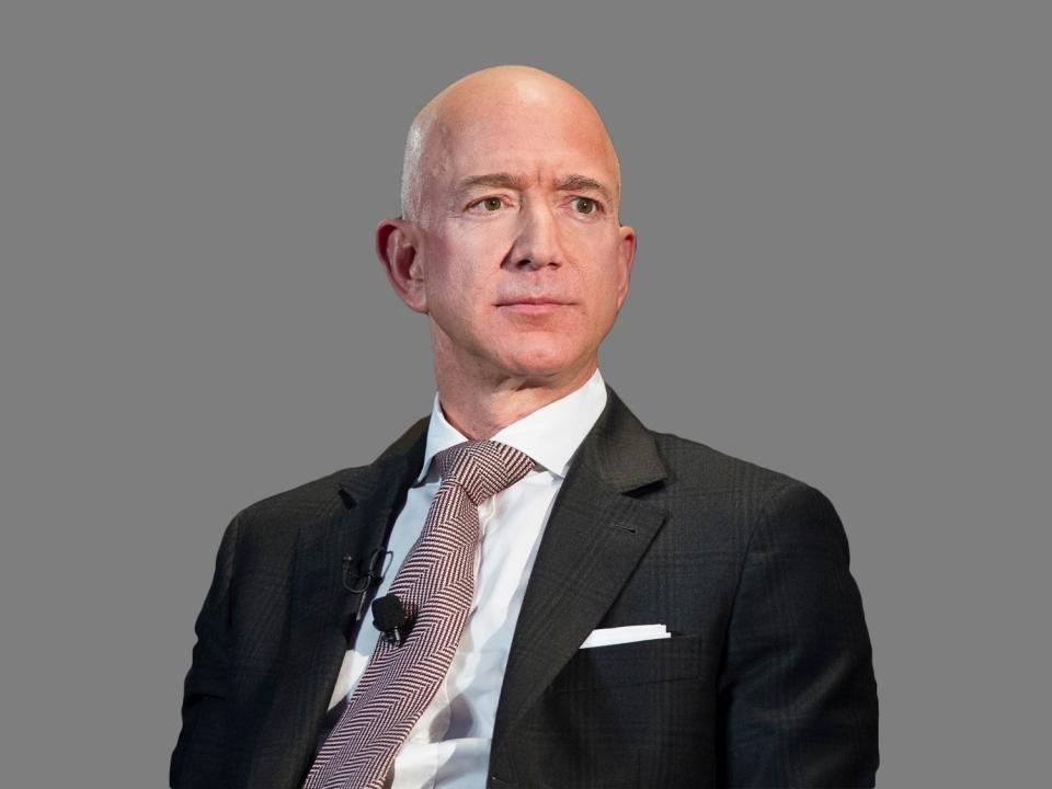 Jeff Bezos headshot, as  Amazon founder and CEO, watches on stage during a news conference unveiling the new Blue Origin rocket at the Cape Canaveral Air Force Station in Cape Canaveral, graphic element on gray
