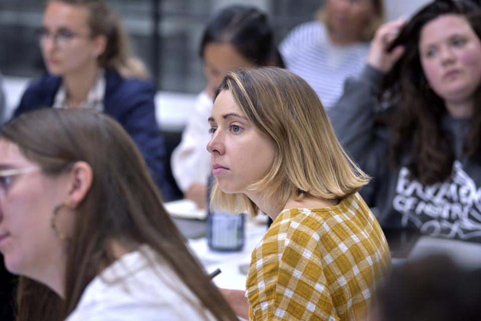 Faith Cerny, a graduate student in City Planning at the Massachusetts Institute of Technology, center, listens during a course concerning the conflicts that arise in the siting process of renewable energy projects at MIT, Friday, Sept. 15, 2023, in Cambridge, Mass. Students get academic credit and hands-on experience addressing real-world dilemmas, while the community and developer get free help resolving conflict. (AP Photo/Josh Reynolds)