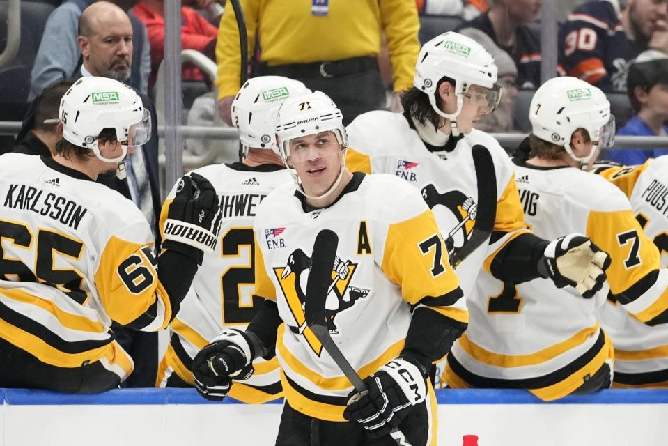 Pittsburgh Penguins' Evgeni Malkin (71) smiles after scoring a goal against the New York Islanders during the second period of an NHL hockey game Wednesday, Dec. 27, 2023, in Elmont, N.Y. (AP Photo/Frank Franklin II)