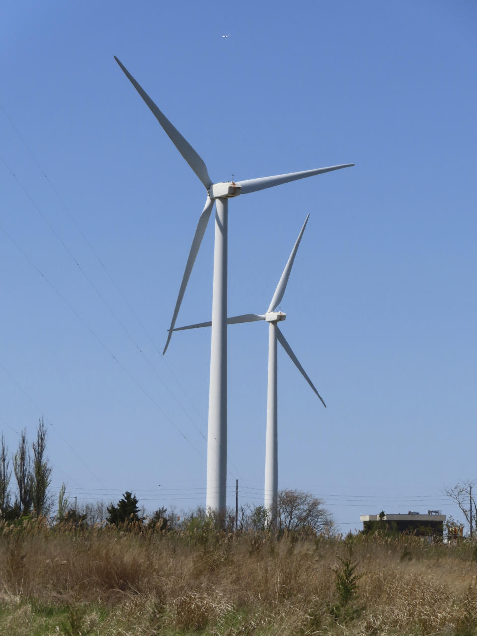 Land-based windmills turn in the wind in Atlantic City, N.J., on April 28, 2022. On July 3, 2023, Atlantic Shores, the approved developer of New Jersey's third offshore wind farm, said it, too, wants a tax break or other financial assistance, hinting that its project might not be able to be done without the kind of assistance New Jersey lawmakers granted the week before to a competitor, Orsted, which has approval to build two of the state's three approved offshore wind farms. (AP Photo/Wayne Parry)
