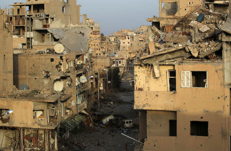 FILE PHOTO: A view shows damaged buildings in Deir al-Zor, eastern Syria February 19, 2014. REUTERS/Khalil Ashawi/File Photo