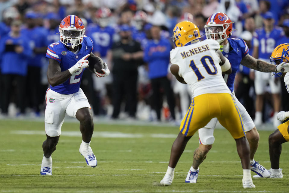 Florida running back Montrell Johnson Jr. (2) runs through an opening past McNeese State defensive back Jaylen Jackson (10) during the first half of an NCAA college football game, Saturday, Sept. 9, 2023, in Gainesville, Fla. (AP Photo/John Raoux)