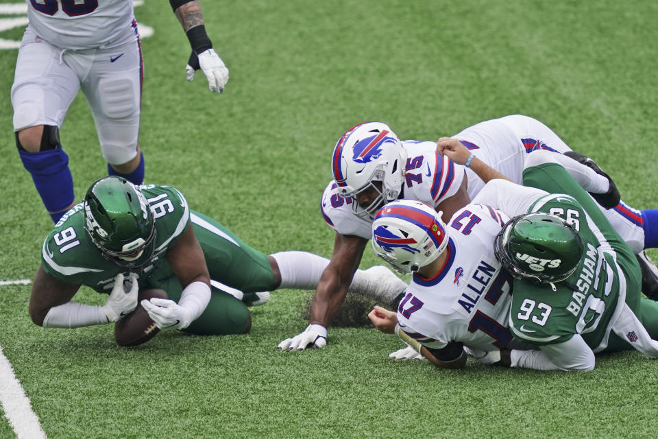 New York Jets' John Franklin-Myers (91), left, recovers the ball fumbled by Buffalo Bills quarterback Josh Allen (17) during the first half of an NFL football game, Sunday, Oct. 25, 2020, in East Rutherford, N.J. (AP Photo/John Minchillo)