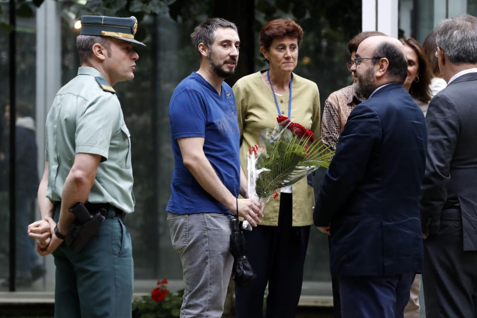 A man brings a bunch of flowers at the Embassy of Spain in Paris.&nbsp;