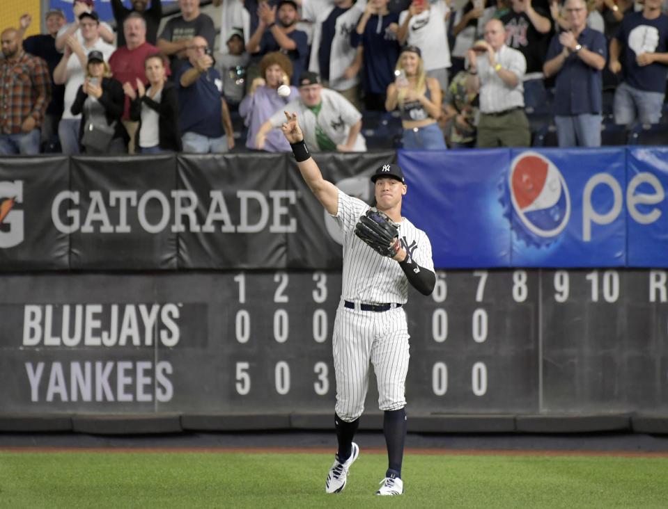 New York Yankees right fielder Aaron Judge gets an ovation from the fans as he warms up coming into the baseball game in the eighth inning against the Toronto Blue Jays Friday, Sept. 14, 2018, at Yankee Stadium in New York. (AP Photo/Bill Kostroun)