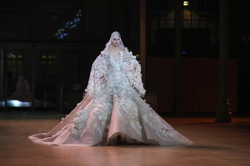 A model wears a creation for the Elie Saab Spring-Summer 2022 Haute Couture fashion collection, in Paris, Wednesday, Jan. 26, 2022. (AP Photo/Francois Mori)