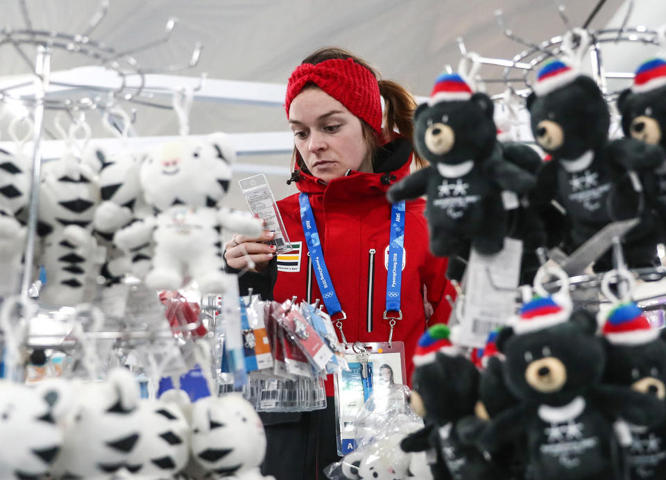 A girl seen by suffed toys of Soohorang and Bandabi, the official mascots of the 23rd Winter Olympic Games and the 12th Winter Paralympic Games in Pyeongchang respectively, on sale in the Olympic Village ahead of the 2018 Winter Olympic Games.