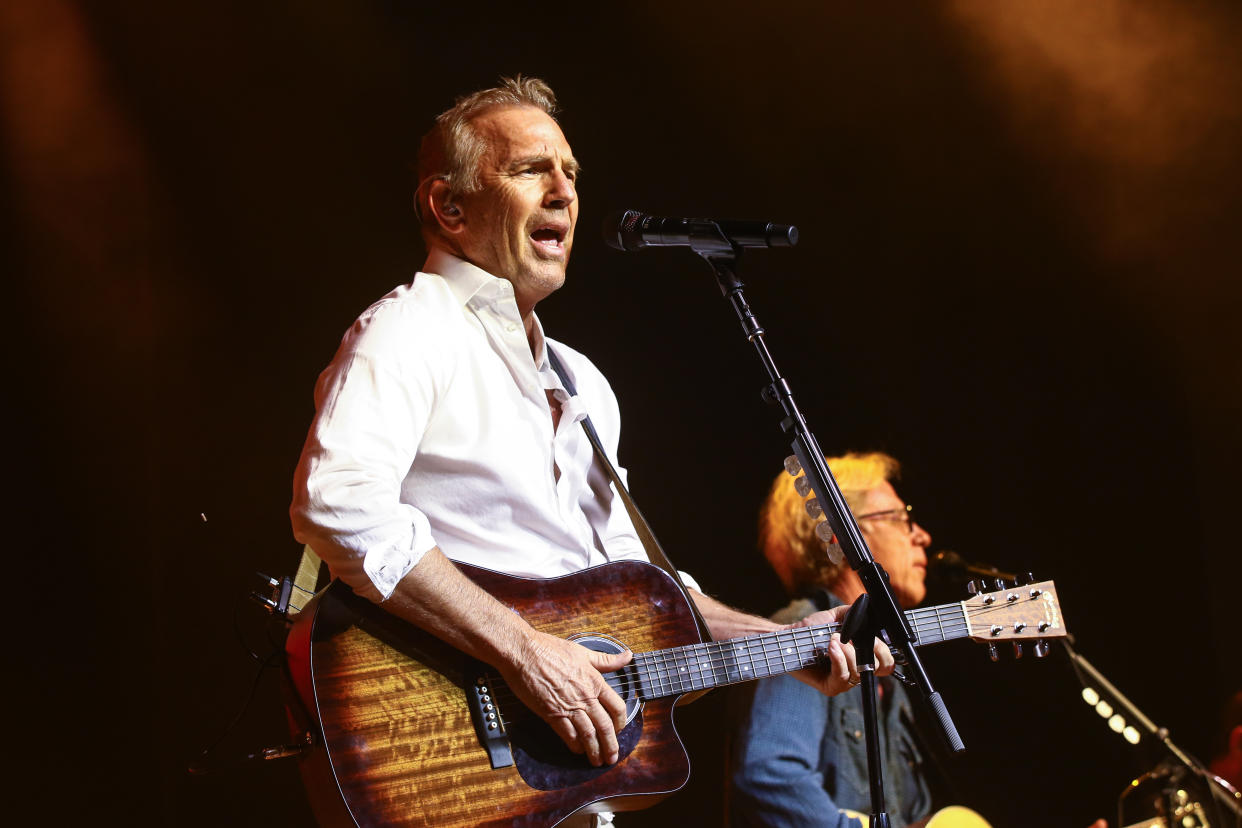 NASHVILLE, TENNESSEE - OCTOBER 26: Kevin Costner performs with his band Modern West on stage at Ryman Auditorium on October 26, 2021 in Nashville, Tennessee. (Photo by Terry Wyatt/Getty Images)