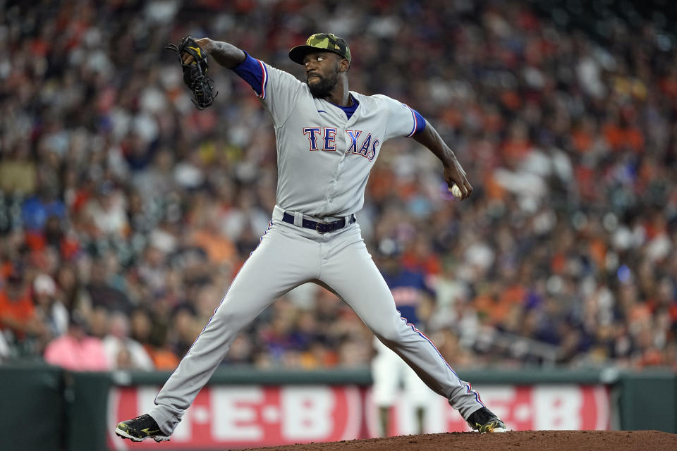Texas Rangers starting pitcher Taylor Hearn throws against the Houston Astros during the first inning of a baseball game Sunday, May 22, 2022, in Houston. (AP Photo/David J. Phillip)