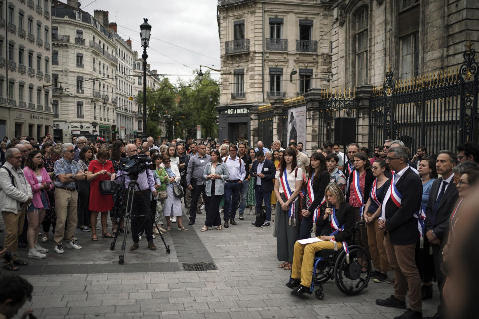 People gather in front of the city hall Monday, July 3, 2023 in Lyon, central France, in a show of solidarity with the mayor of the Paris suburb of L'Hay-les-Roses after a burning car struck his home. Unrest across France sparked by the police shooting of a 17-year-old appeared to slow on its sixth night, but still public buildings, cars and municipal trash cans were targeted nationwide by fires and vandalism overnight into Monday. (AP Photo/Laurent Cipriani)