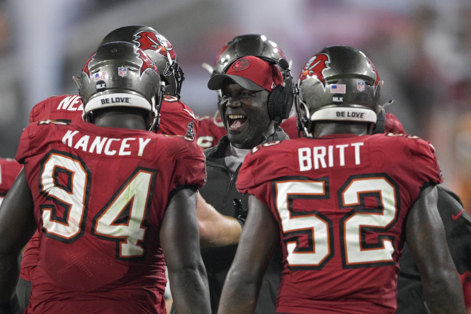 Tampa Bay Buccaneers head coach Todd Bowles, center, reacts while talking to players including defensive tackle Calijah Kancey (94) and linebacker K.J. Britt (52) during the second half of an NFL wild-card playoff football game against the Philadelphia Eagles, Monday, Jan. 15, 2024, in Tampa, Fla. (AP Photo/Phelan M. Ebenhack)