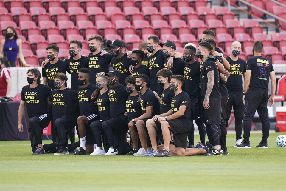 Players from Los Angeles FC pose for a group photo on the field prior to the announcement that their game against Real Salt Lake was called off Wednesday, Aug. 26, 2020, in Sandy, Utah. Major League Soccer players boycotted five games Wednesday night in a collective statement against racial injustice. The players' action came after all three NBA playoff games were called off in a protest over the police shooting of Jacob Blake in Wisconsin on Sunday night. (AP Photo/Rick Bowmer)