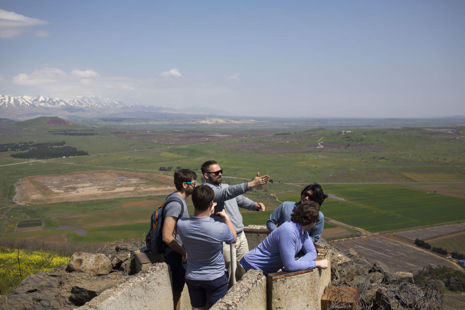 Tourists visit an old military outpost overlooking to Syria in the Israeli controlled Golan Heights, Friday, March 22, 2019. President Donald Trump abruptly declared Thursday the U.S. will recognize Israel's sovereignty over the disputed Golan Heights, a major shift in American policy that gives Israeli Prime Minister Benjamin Netanyahu a political boost a month before what is expected to be a close election.(AP Photo/Ariel Schalit)