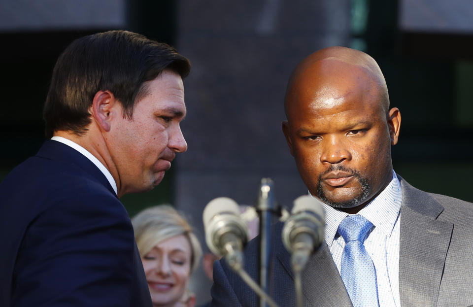 Florida Gov. Ron DeSantis, left, introduces acting sheriff Gregory Tony at the Broward County Sheriff's Office Fort Lauderdale headquarters, Jan. 11, 2019, in Fort Lauderdale, Fla. Gov. DeSantis said on Feb. 1 that he and his staff would “in the coming days” review a state report that found the sheriff he appointed lied repeatedly about killing another teenager almost 30 years ago, his past drug use and his driving record. That was 100 days ago on Wednesday, May 11, 2022 and neither DeSantis nor his staff have made any announcement about whether he will discipline Gregory Tony. (AP Photo/Wilfredo Lee)