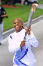 Tennis superstar Serena Williams carries the Olympic flame as a torchbearer during the 2002 Olympic Torch Relay Saturday, Dec. 8, 2001, in Ft. Laurderdale, Fla. The torch makes its journey to Salt Lake City traveling more than 13,500 miles across the United States in 65 days carried by about 11,500 torchbearers (AP Photo/Todd Warshaw, Pool)