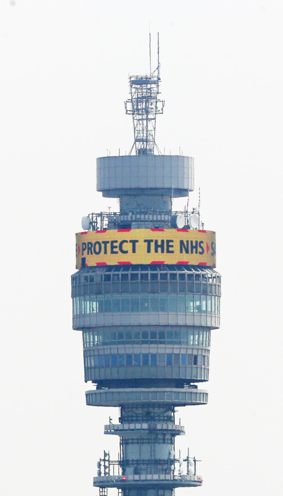 The government's message: 'Stay Home, Protect the NHS, Save Lives' is shown in lights on the rotating display near the top of the BT Tower in the Fitzrovia area of London as the UK continues in lockdown to fight the coronavirus pandemic.