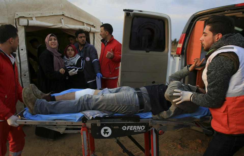 Medics move a wounded protester to a field clinic tent after being shot during a protest near the fence of the Gaza Strip border with Israel, near Beit Lahiya, northern Gaza Strip, Tuesday, Feb. 19, 2019. (AP Photo/Adel Hana)