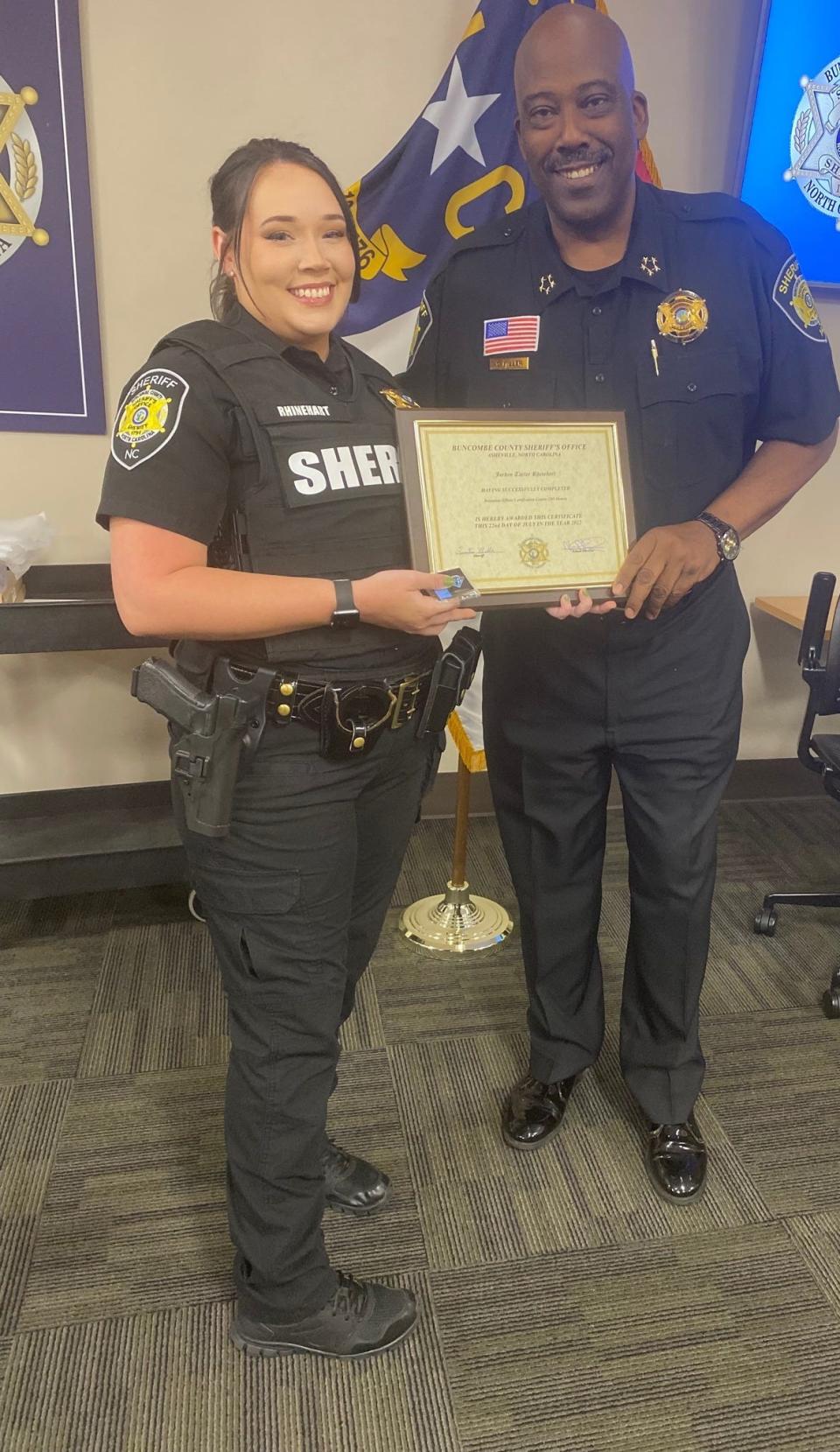 In a photo posted to the department's Facebook page July 22, Buncombe County Sheriff's Office deputy Jordan Rhinehart with Sheriff Quentin Miller receives a training certificate.